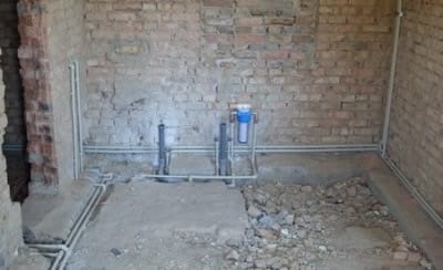 В частном доме при использовании коллекторной схемы водопроводные трубы можно спрятать даже под стяжку